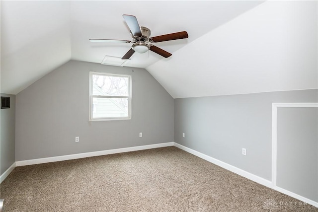 additional living space featuring vaulted ceiling, carpet floors, visible vents, and baseboards