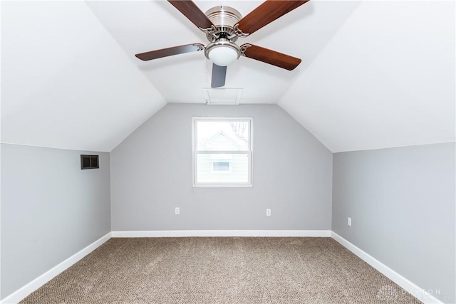 additional living space featuring lofted ceiling, a ceiling fan, visible vents, baseboards, and carpet