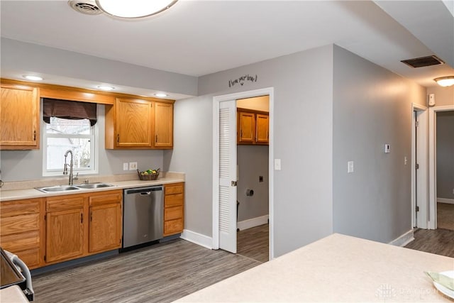 kitchen with visible vents, dark wood-type flooring, light countertops, stainless steel dishwasher, and a sink