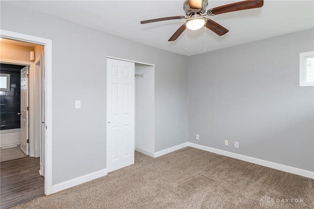 unfurnished bedroom featuring ceiling fan, a closet, carpet flooring, and baseboards