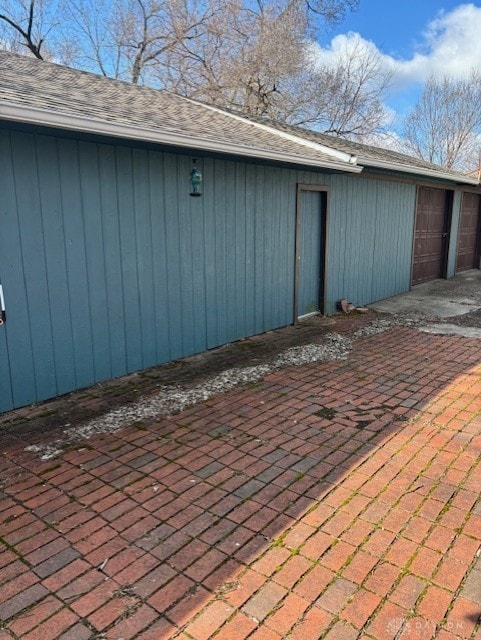 exterior space featuring a garage and an outbuilding