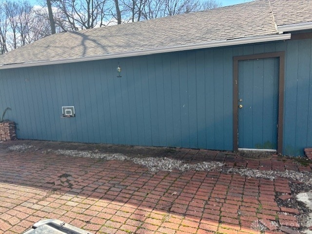 exterior space with roof with shingles