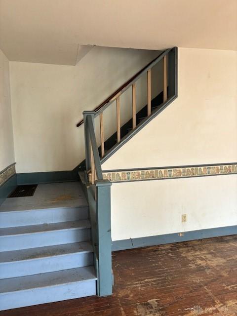 staircase with hardwood / wood-style flooring