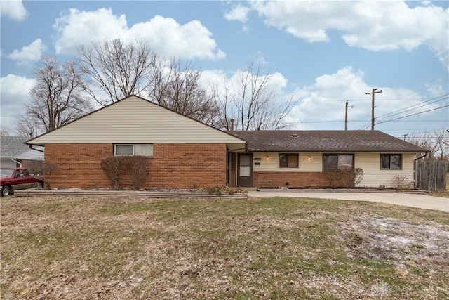 view of front facade with a front yard and brick siding