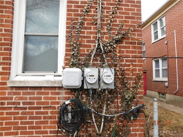 exterior details with electric meter and brick siding