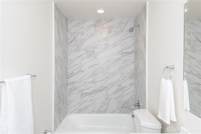 bathroom with toilet and  shower combination