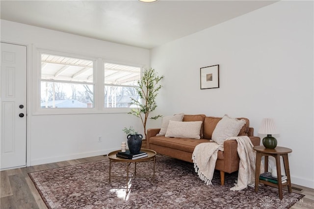 living area featuring wood finished floors and baseboards
