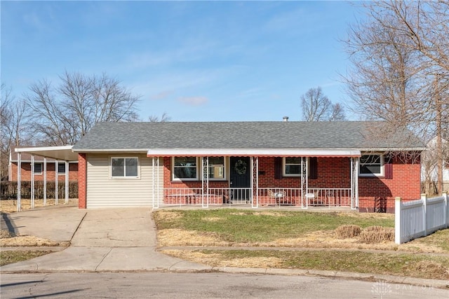 ranch-style home with brick siding, fence, covered porch, a carport, and driveway