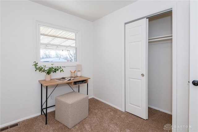 office space with baseboards, visible vents, and carpet floors
