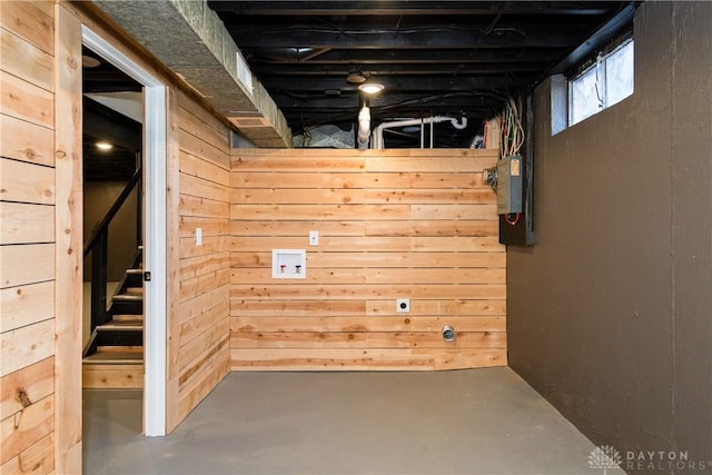 below grade area with wooden walls and stairway
