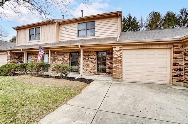 traditional home with a garage, concrete driveway, brick siding, and roof with shingles