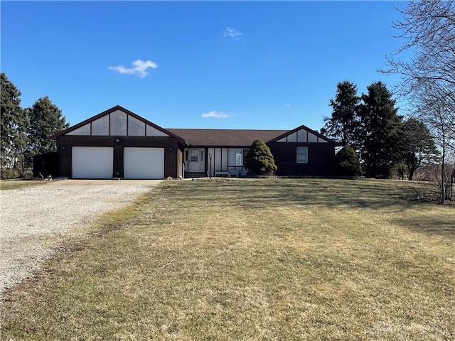 view of front of property featuring a front lawn, driveway, and an attached garage