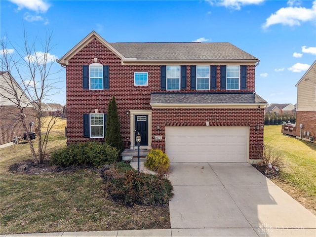 view of front of home with a garage, driveway, a front lawn, and brick siding