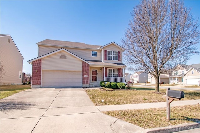 traditional home featuring covered porch, concrete driveway, a front lawn, and brick siding