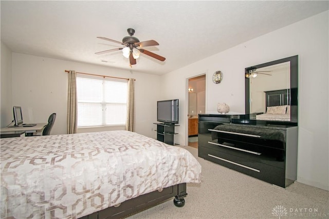 bedroom featuring connected bathroom and a ceiling fan