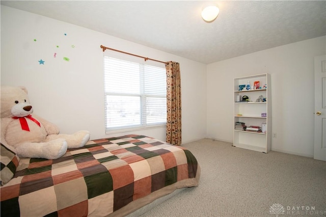 carpeted bedroom featuring a textured ceiling