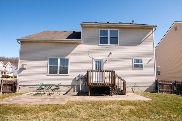 rear view of property with a yard, fence, and a patio