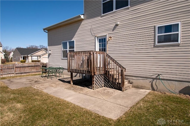 doorway to property with a yard, a patio area, and fence