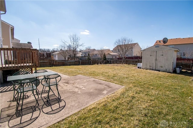 view of yard featuring a patio area, an outdoor structure, a fenced backyard, and a shed