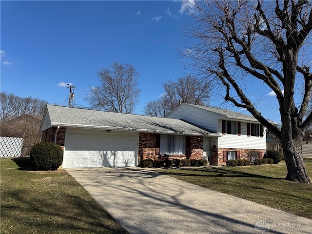 split level home featuring brick siding, concrete driveway, roof with shingles, an attached garage, and a front yard