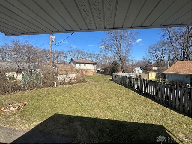 view of yard featuring an outdoor structure and fence