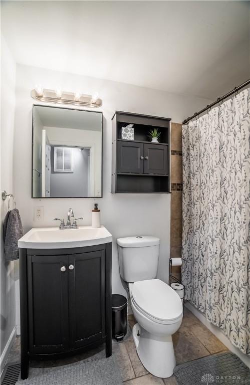 full bath featuring toilet, a shower with shower curtain, and vanity