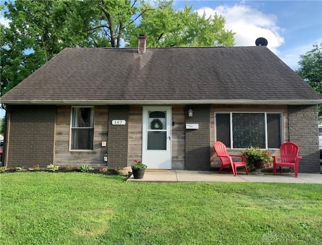 147 Mccraw Dr, Englewood, OH 45322 - view of front facade with brick siding, roof with shingles, and a front lawn