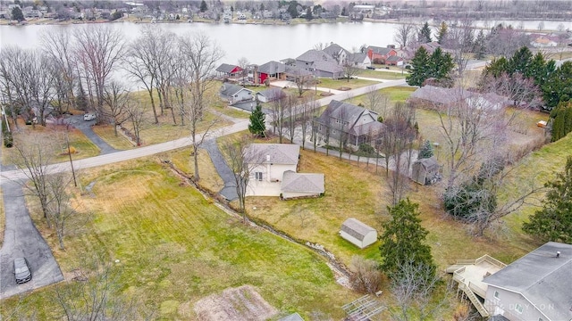 drone / aerial view with a water view and a residential view