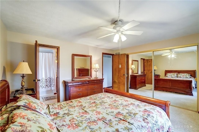 bedroom with a ceiling fan, carpet, a closet, and ensuite bathroom