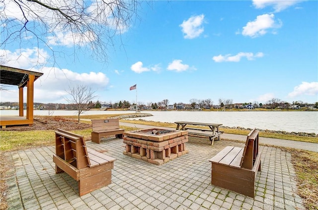 view of patio / terrace with a water view and an outdoor fire pit