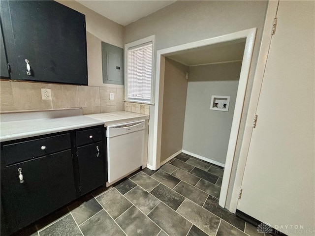 kitchen featuring dishwasher, light countertops, electric panel, decorative backsplash, and dark cabinetry