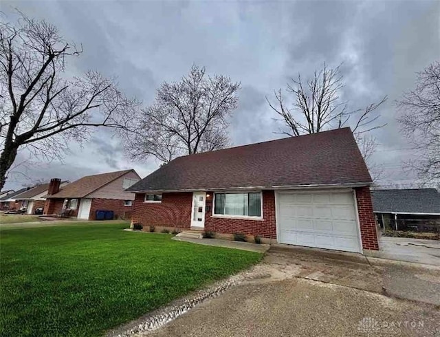 view of front of house featuring driveway, a front lawn, an attached garage, a shingled roof, and brick siding