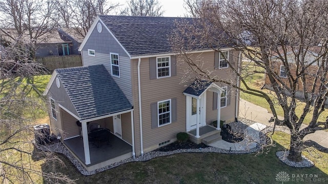 view of front of property with crawl space, a shingled roof, fence, and a patio