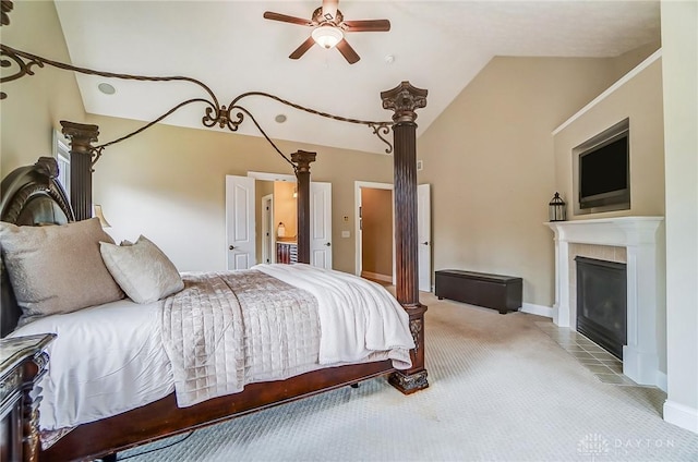 bedroom featuring lofted ceiling, carpet flooring, baseboards, and a tile fireplace