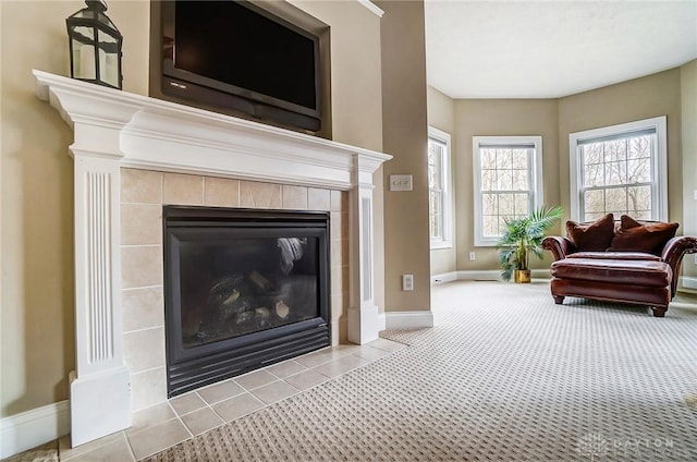 living room with a fireplace, carpet flooring, and baseboards