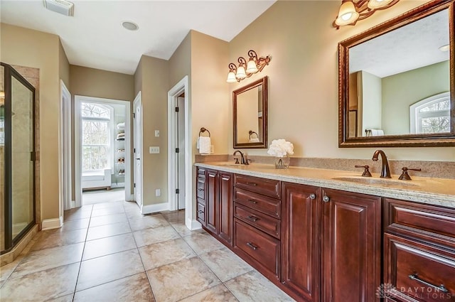 full bath featuring a wealth of natural light, visible vents, and a sink