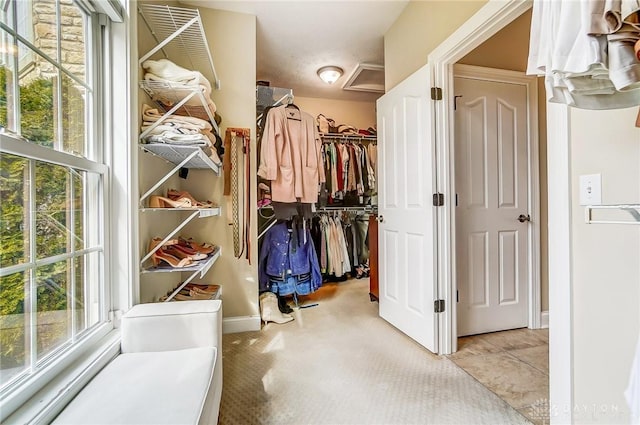 walk in closet featuring attic access and tile patterned floors