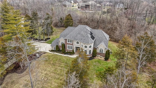 birds eye view of property featuring a wooded view