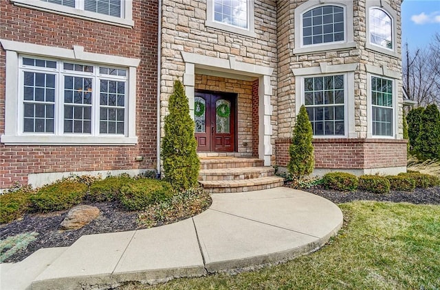 view of exterior entry with brick siding