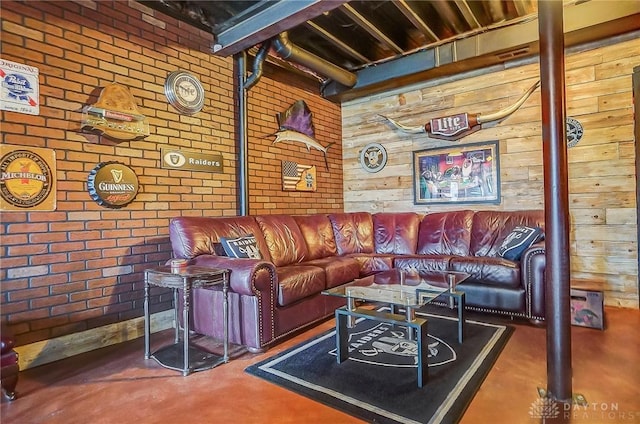 living room featuring brick wall and finished concrete floors