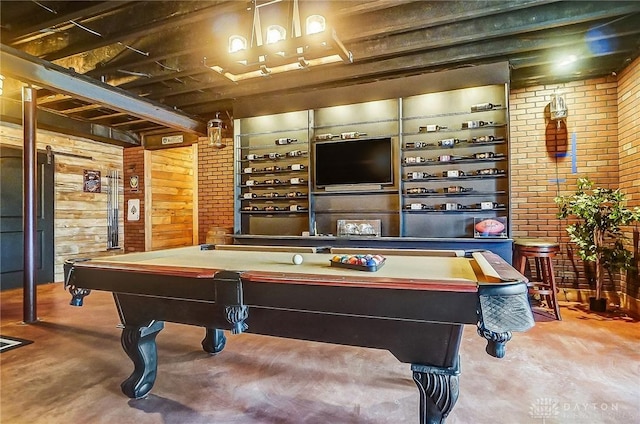 playroom featuring wood walls, brick wall, and pool table