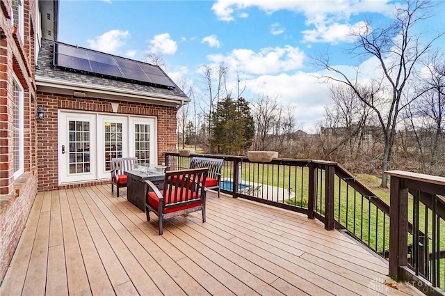 wooden terrace featuring outdoor dining space and a lawn