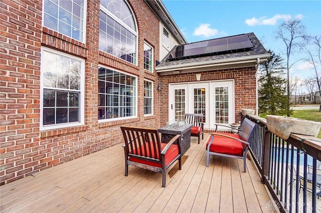 deck with an outdoor living space with a fire pit