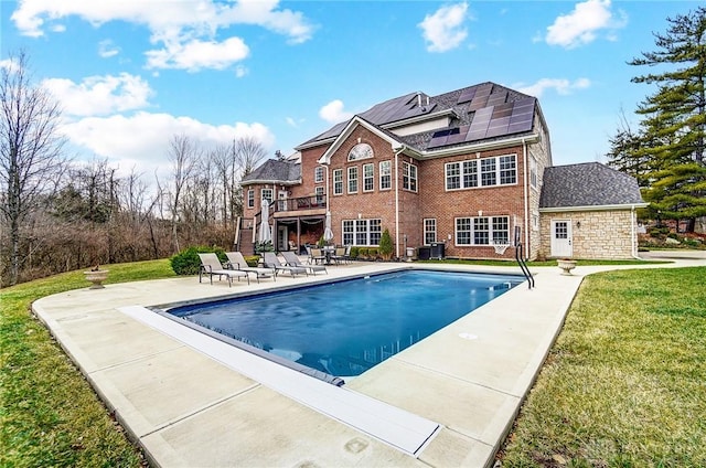 pool featuring stairway, a patio area, a lawn, and a deck