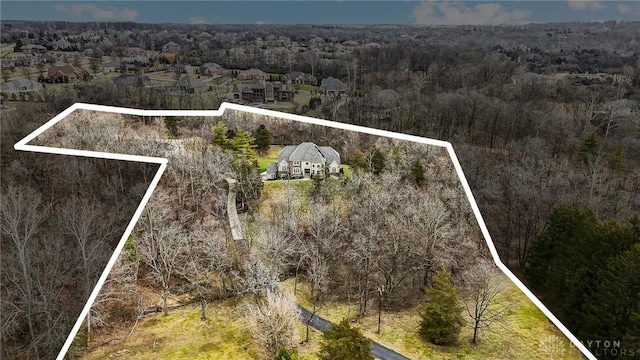 birds eye view of property with a wooded view