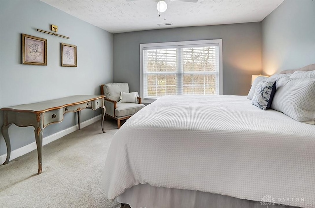 bedroom featuring a textured ceiling, carpet, visible vents, and baseboards