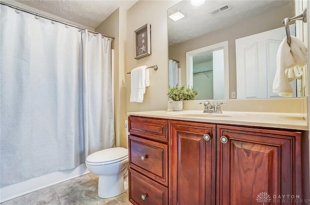 full bathroom with visible vents, toilet, a textured ceiling, vanity, and tile patterned flooring