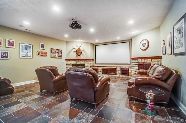 cinema featuring recessed lighting, a fireplace, and baseboards