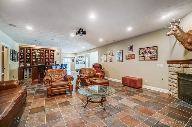 living room with a fireplace, baseboards, and recessed lighting