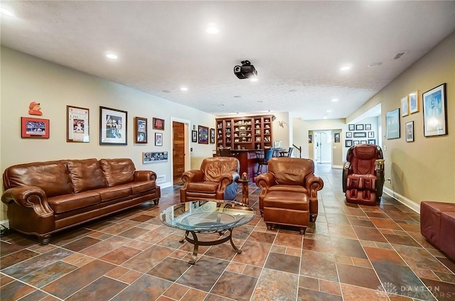 living room featuring baseboards and recessed lighting